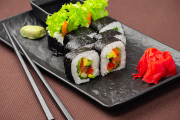 sushi on a black plate