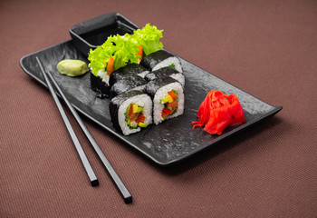 sushi on a black plate