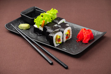 sushi on a black plate