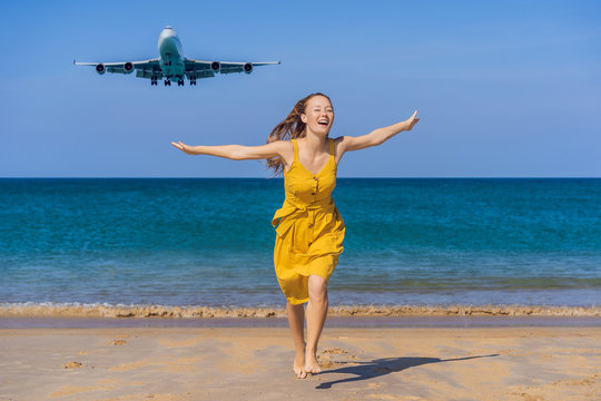 Woman have fun on the beach watching the landing planes. Traveling on an airplane concept. Text space. Island Phuket in Thailand. Impressive paradise. Hot beach Mai Khao. Amazing landscape