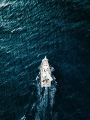 Aerial view of Sailing ship yachts with white sails  in deep blue sea