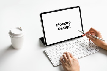 Woman typing keyboard laptop and tablet screen blank on the table mock up to promote your products. Concept of future and trend internet for easy access to information.