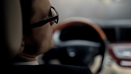 Back view of sad businessman waiting in traffic jam, late for important meeting