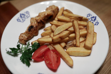 Shish kebab with fried potatoes