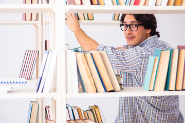 Male student preparing for exams at library 