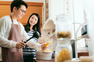 Attractive Asian couple marry family  preparing cooking food dinner together with happiness and...