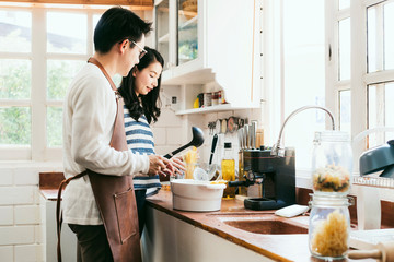 Attractive Asian couple marry family preparing cooking food dinner together with happiness and freshful in home kitchen family ideas concept