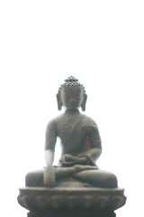 Statue or figurine of sitting black indian buddha on white background