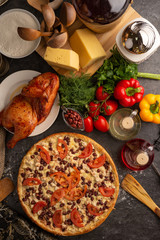 Pizza chicken, red beans and tomatoes for a restaurant menu.