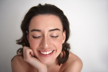 Portrait of happy smiling woman closing eyes