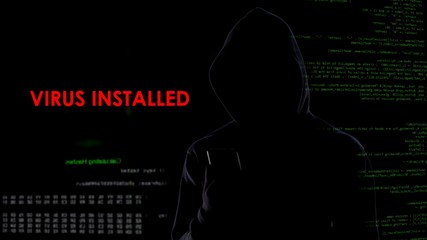 Male hacker installed virus on enemy laptop, malicious software computer program