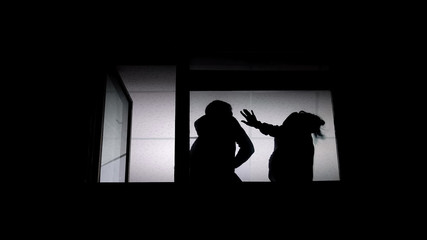 Shadow of husband and wife arguing, man slapping woman, domestic violence