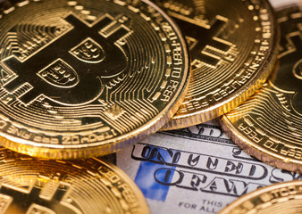 Fototapeta na wymiar Bitcoins (Cryptocurrency) and dollars banknotes background