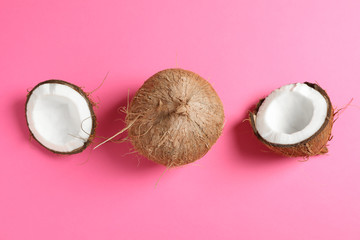 Two coconut one of which split on color background, space for text