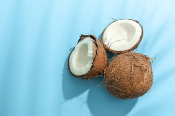 Two coconut one of which split on color background