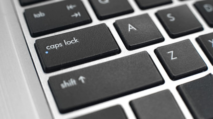 Switched on caps lock button on keyboard, typing capital letters, toggle key