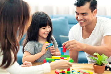 happy family caucasian and asian mixed race with pretty daughter enjoy family time with toy  together living room home background