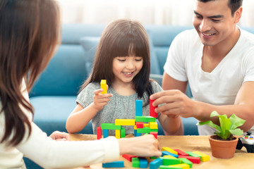 happy family caucasian and asian mixed race with pretty daughter enjoy family time with toy  together living room home background