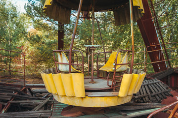 Fototapeta na wymiar Abandoned amusement park in the city center of Prypiat in Chornobyl exclusion zone. Radioactive zone in Pripyat city - abandoned ghost town. Chernobyl history of catastrophe