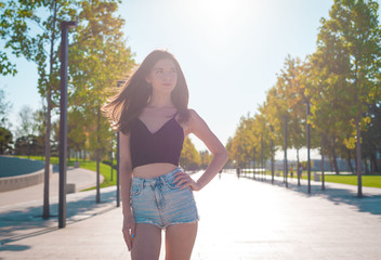 Girl, jeans shorts, black t-shirt,  street