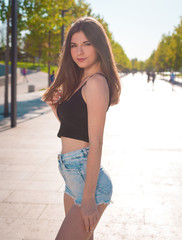 Girl, jeans shorts, black t-shirt,  street