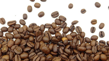 Close up of roasted coffee beans on white background