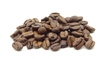 Close up of roasted coffee beans on white background
