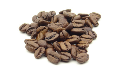Close up of roasted coffee beans on white background