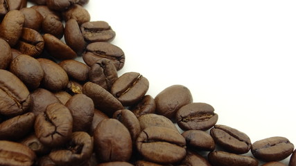 Close up of roasted coffee beans on white background