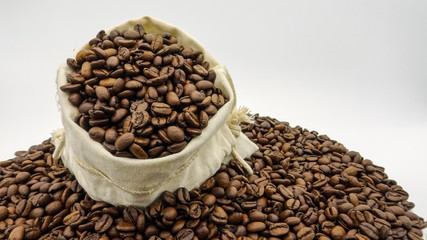 A sack with roasted coffee beans on white background