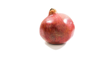 Whole pomegranate isolated on white background