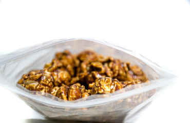 Chocolate covered popcorn in a clear plastic bag.