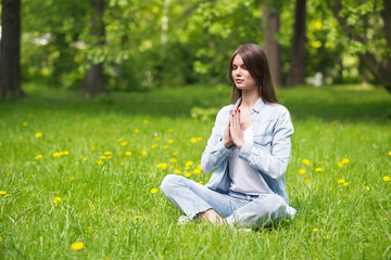 Young girl meditating in park