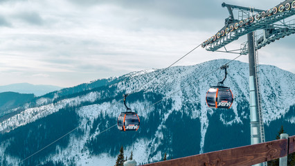 Jasna resort, LIPTOV, SLOVAKIA - February, 2019: Blue sky with snow clouds and new modern lift Funitel in Jasna, Liptov region, Slovakia.