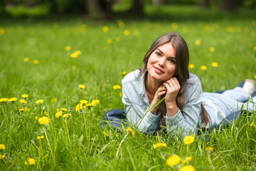 Woman laying on grass in park