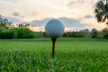 Golf ball on tee during Florida sunset
