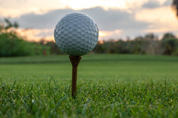 Golf ball on tee during Florida sunset