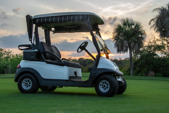 Golf cart on Florida golf course at sunset