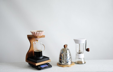 Manual coffee brewing. Pink ceramic origami dripper. Wooden stand. Gringer, gooseneck kettle....