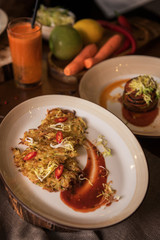 Healthy vegeterian food on brown wood board. Spring vitamin dieting food. Potato vegan pancakes with juice fruit and vegetables
