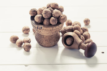 Italian nuts. Wooden nutcracker. Scattered nuts on a table with shallow depth of depth and depth.
