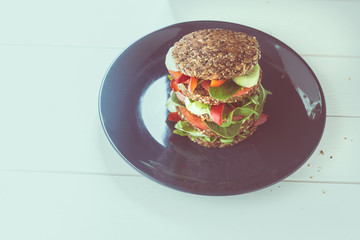 Big Vegetarian sandwich on the plate. Snack at work. Shallow depth of field and graphic filter.