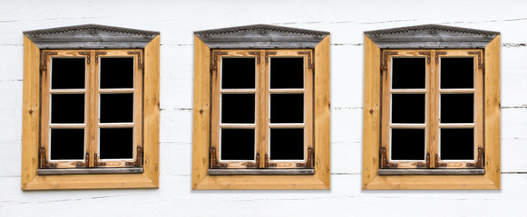 Three wooden rustic windows in small cottage house. Vintage white paint wood wall.