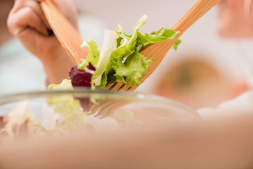 Close-up of cooking healthy fresh salad at kitchen