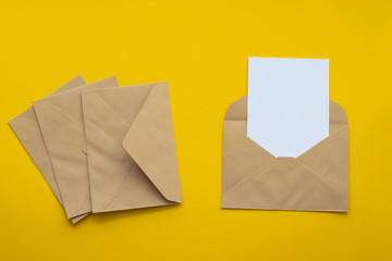 Blank white card with kraft brown paper envelope template mock up