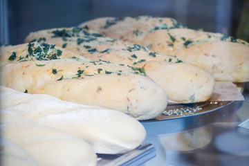 close-up of baguettes or buns on a shop window
