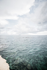 Fototapeta premium Dramatic view of the horizon on a rainy day from the tourist port of Ortigia in Syracuse.