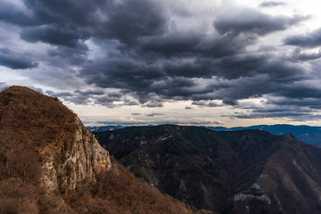 Naklejka na ściany i meble Dramatic clouds in Rhodope mountain, Bulgaria. Last days of winter landscape