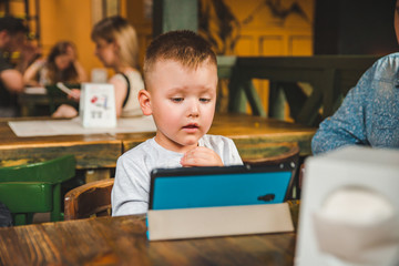 Fototapeta na wymiar little boy sitting with tablet