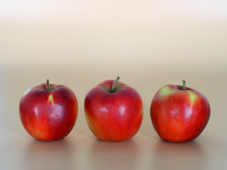 three juicy red apples